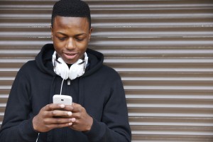 Young black teen texting